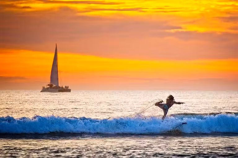 surf en Playa Tamarindo al atardecer.